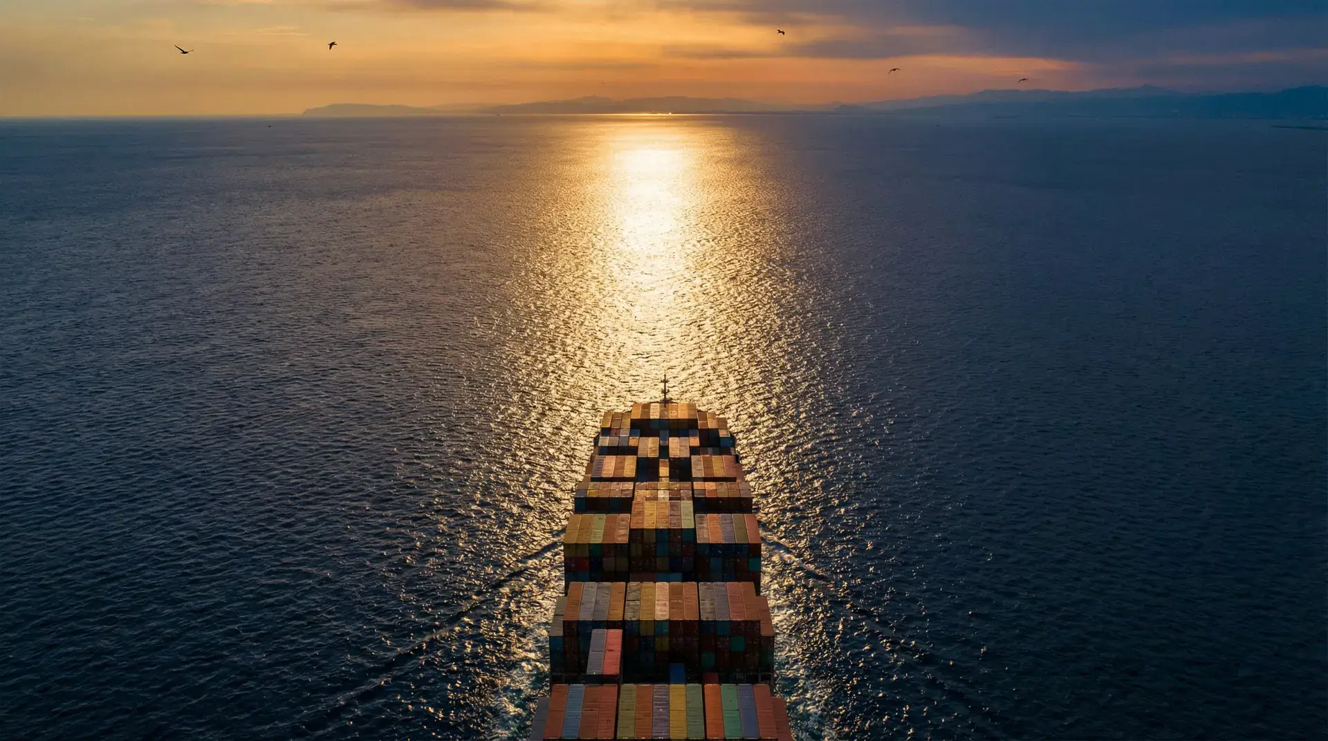 Cargo ship crossing the ocean at dusk